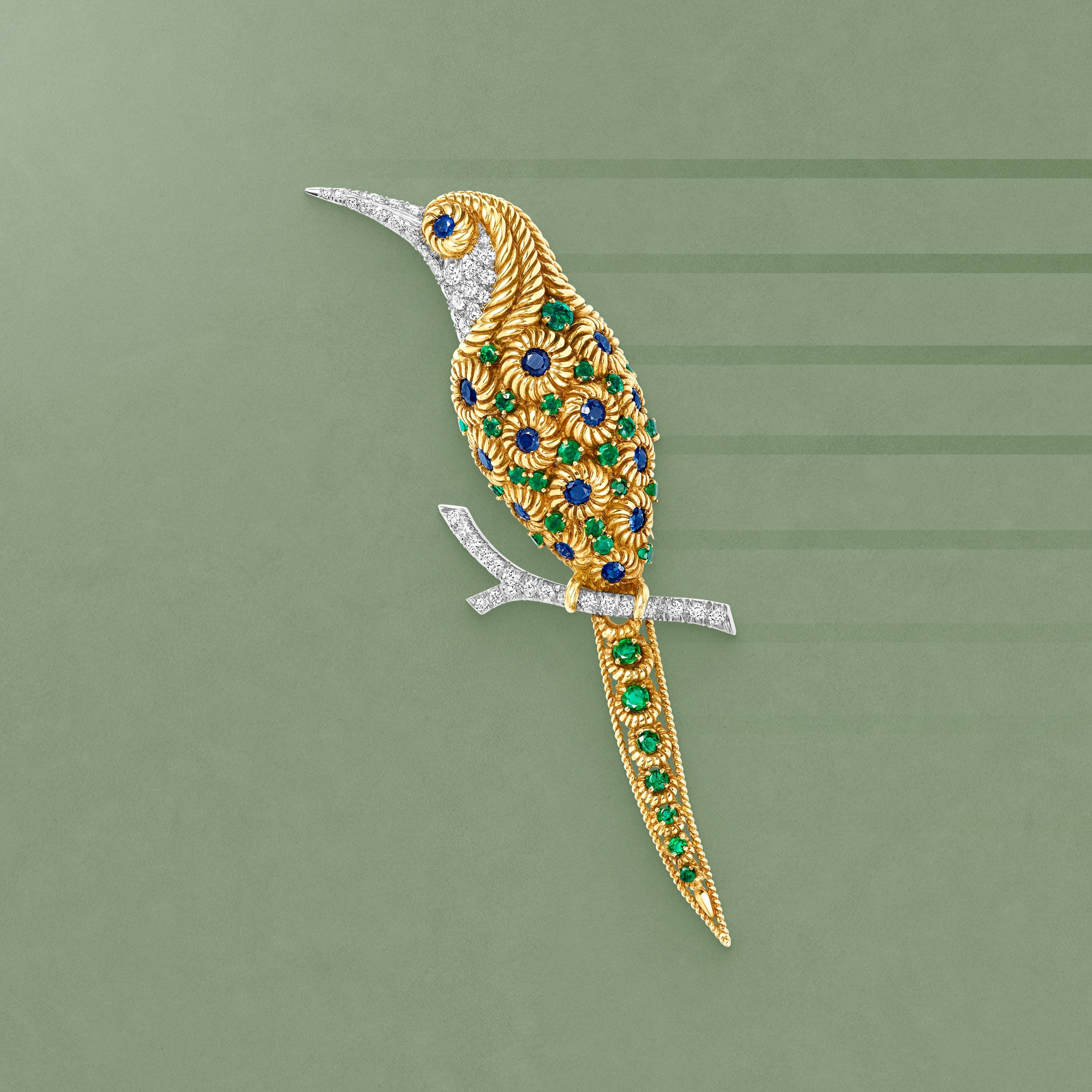 Bird Clip, 1966. 18K yellow gold, sapphires, emeralds, diamonds. Van Cleef & Arpels Collection.