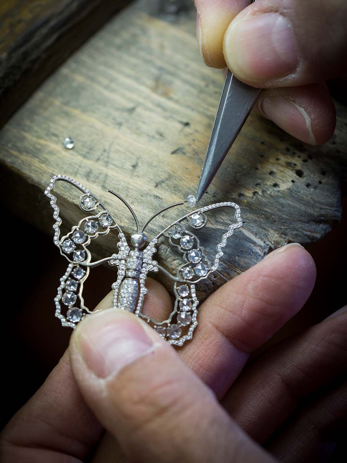 Positioning diamonds in the white gold wings of the butterfly, Fée Ondine automaton. Extraordinary Object, Van Cleef & Arpels