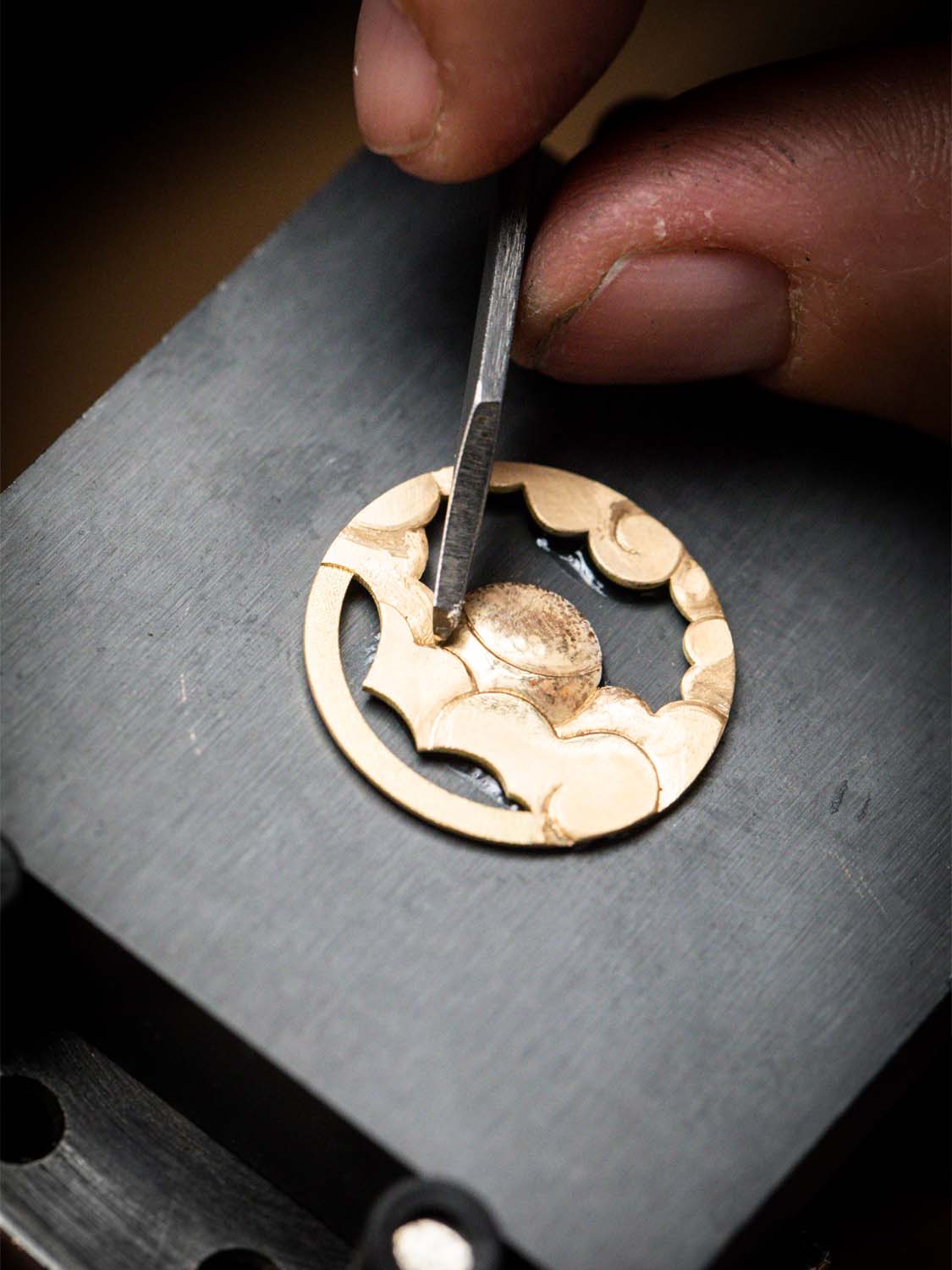 Work on a yellow gold piece of the mechanism, Planetarium automaton. Extraordinary Object, Van Cleef & Arpels